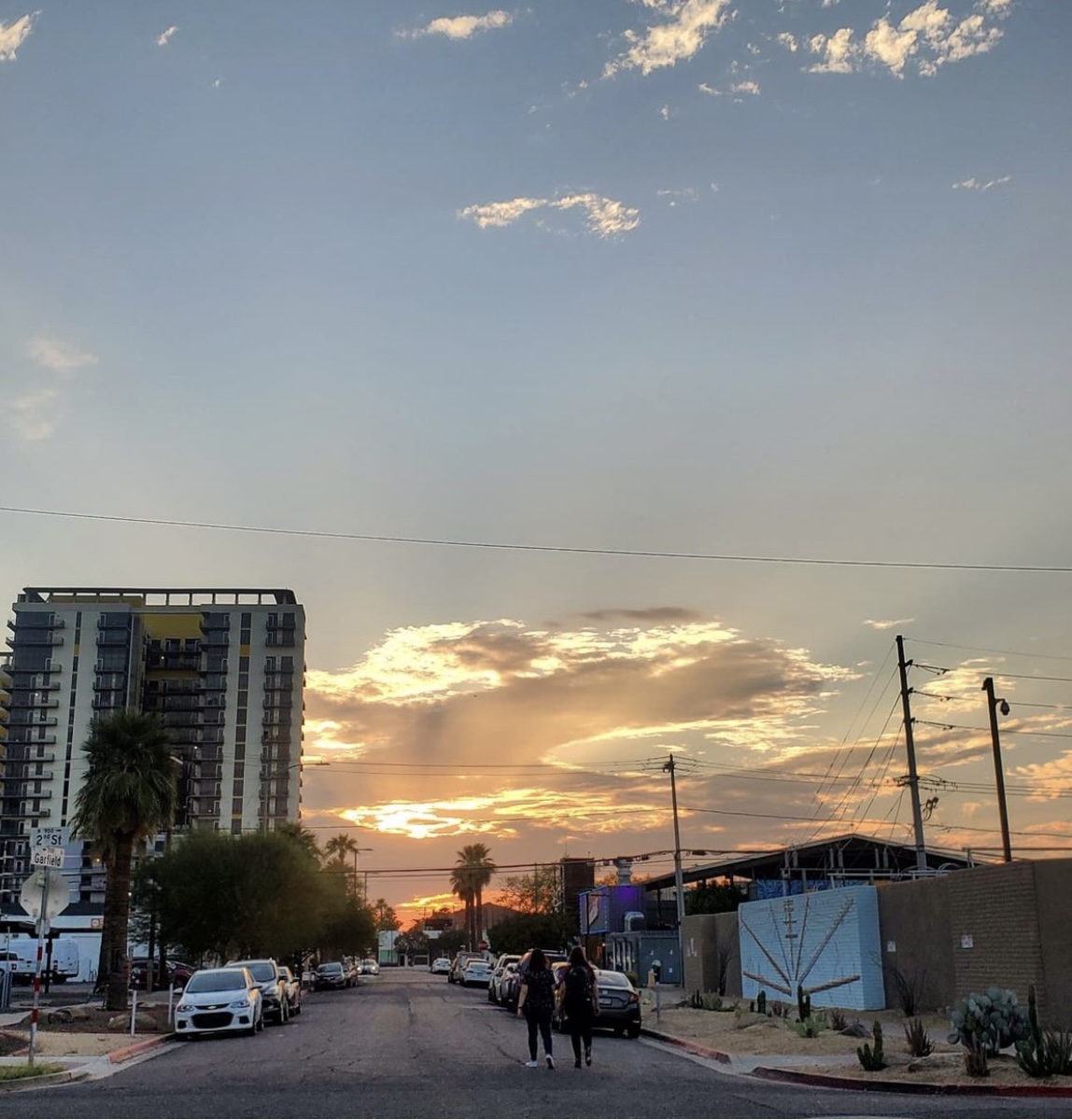 A photo of a street view landscape of a sunset and skyscraper buildings